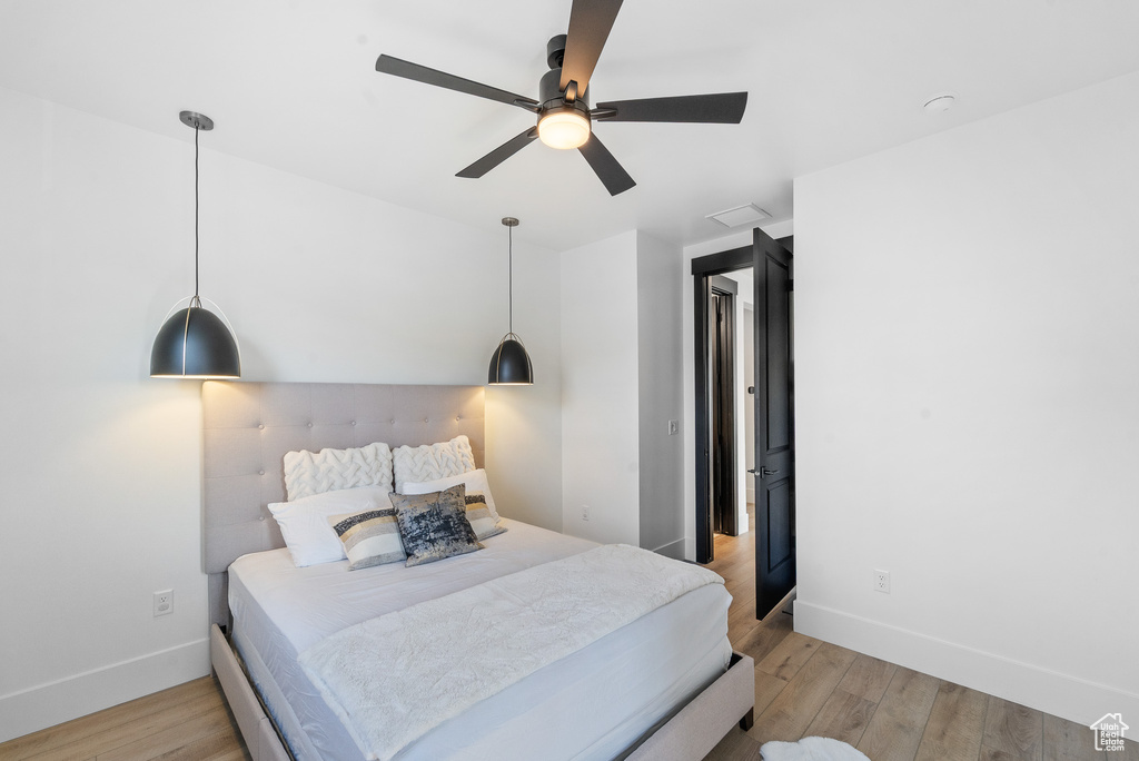 Bedroom with light wood-style flooring and a ceiling fan