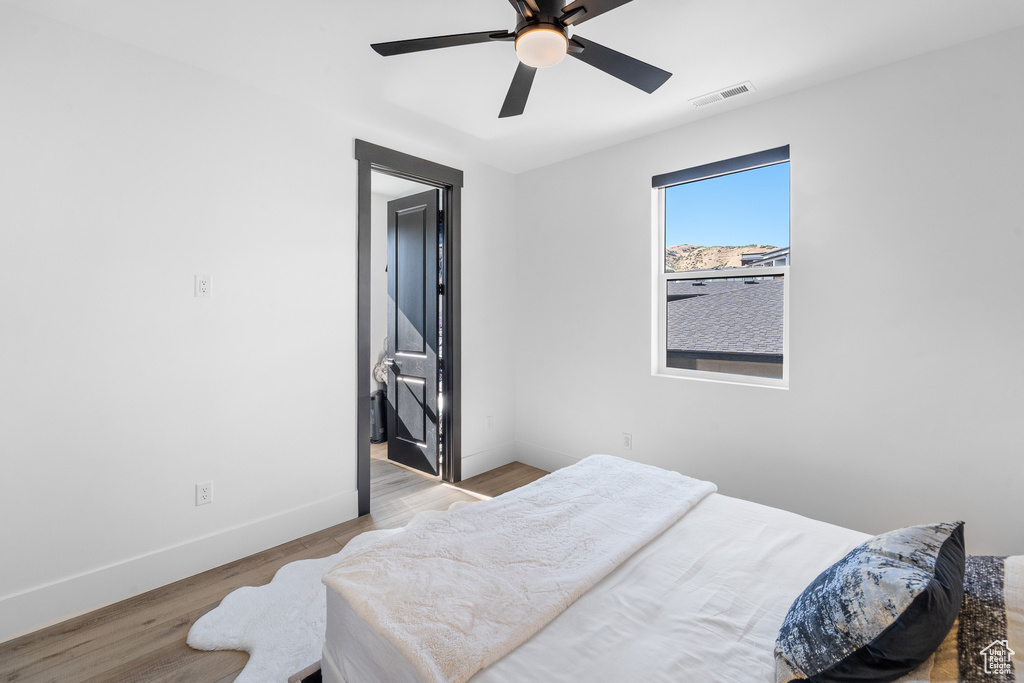 Bedroom with wood finished floors and ceiling fan