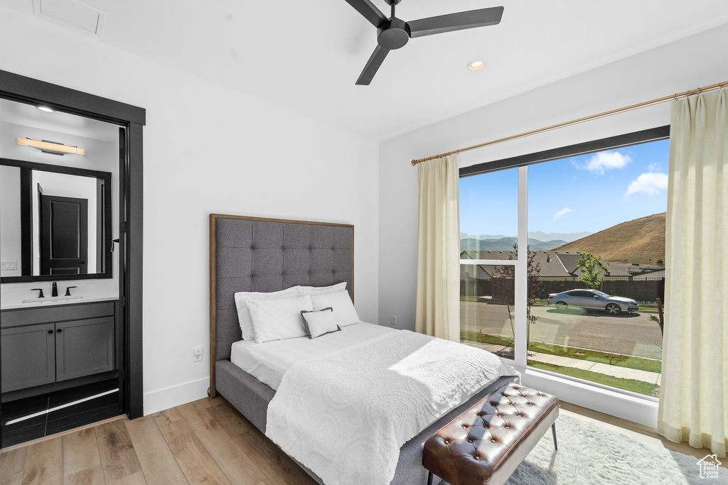 Bedroom featuring a mountain view, light wood finished floors, recessed lighting, and a ceiling fan