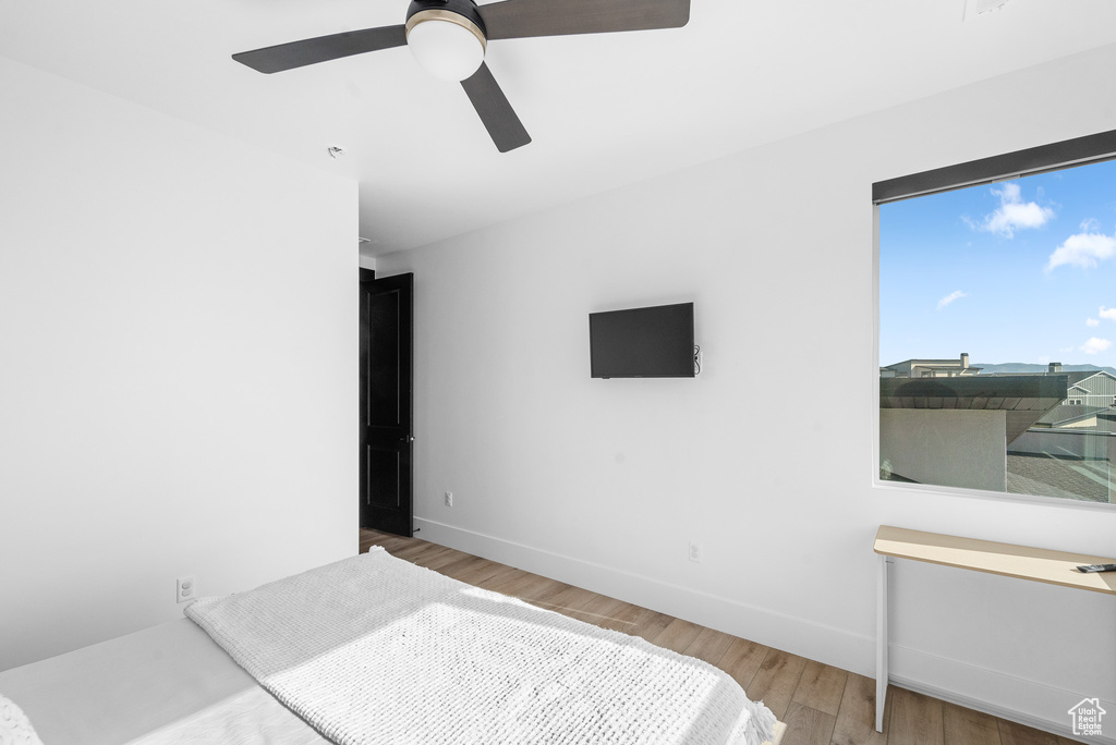 Bedroom with wood finished floors and ceiling fan
