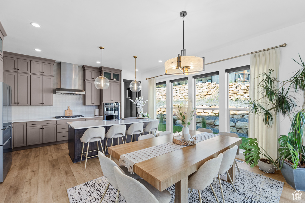 Dining space featuring light wood finished floors and recessed lighting