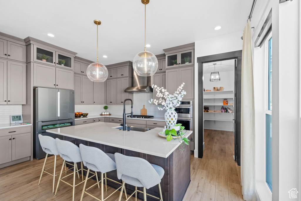 Kitchen featuring stainless steel appliances, gray cabinets, backsplash, and recessed lighting