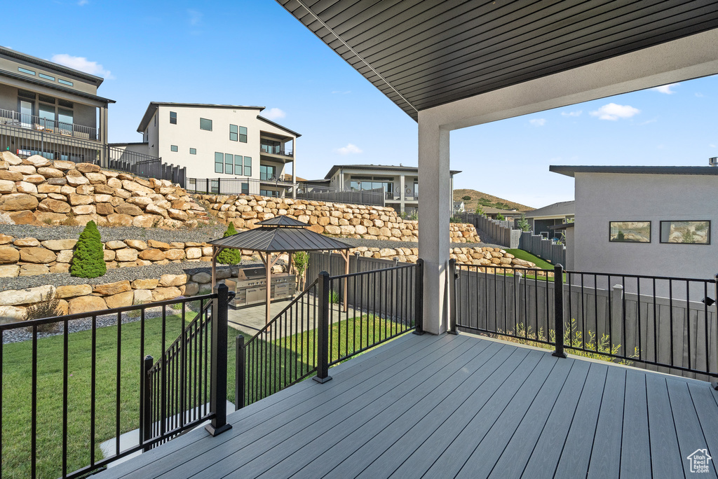 Wooden deck with a gazebo and a residential view