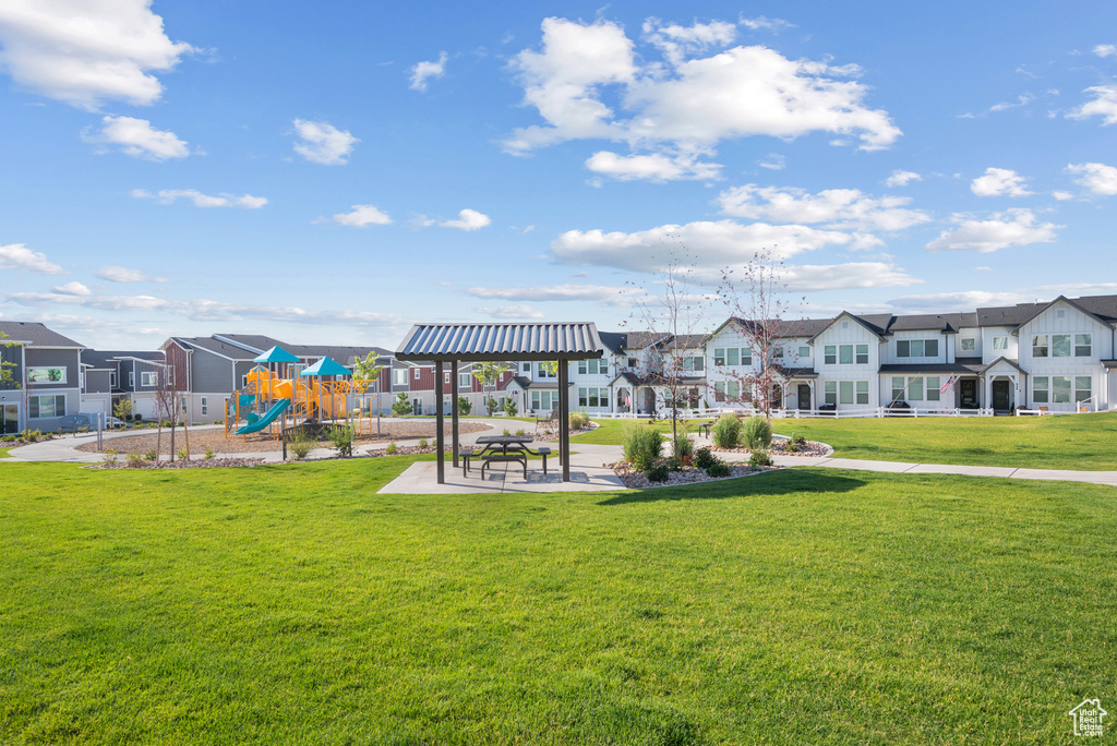 Community jungle gym featuring a residential view and a yard