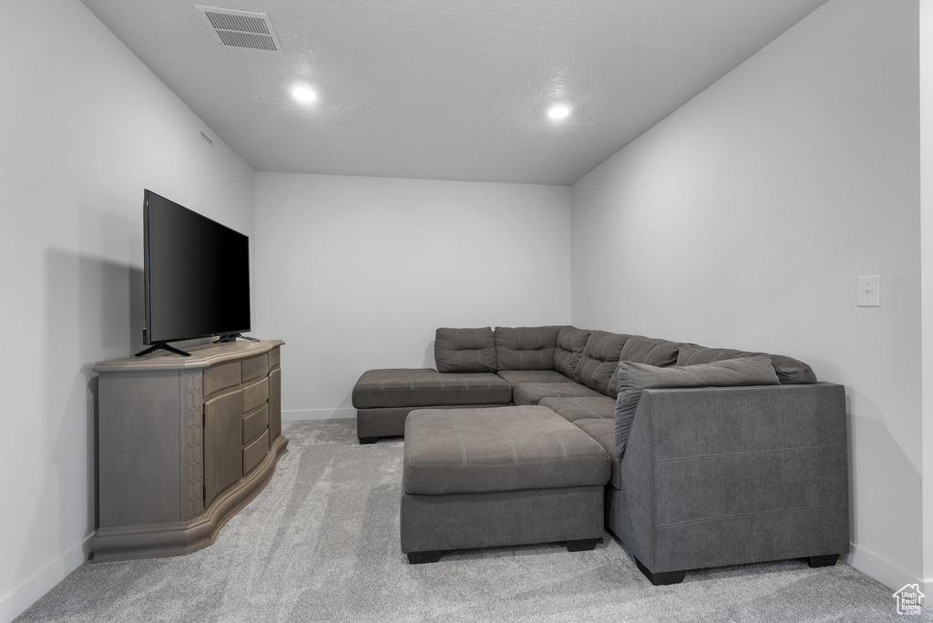 Living room featuring recessed lighting and light carpet