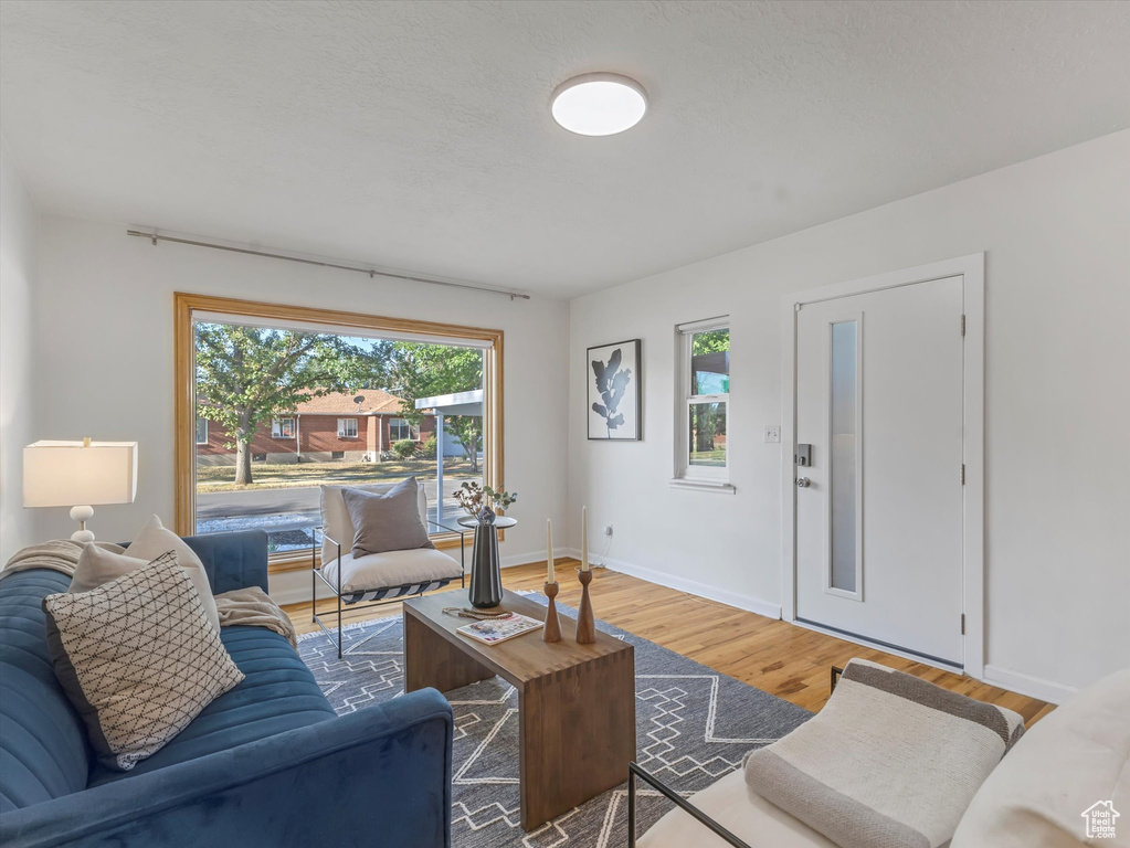 Living area with wood finished floors and baseboards