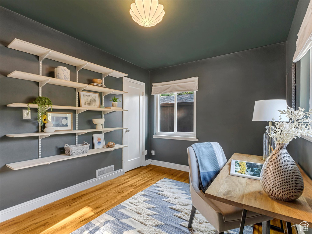 Office space with wood finished floors and baseboards