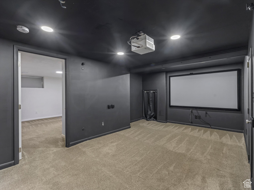 Home theater room with light carpet and recessed lighting