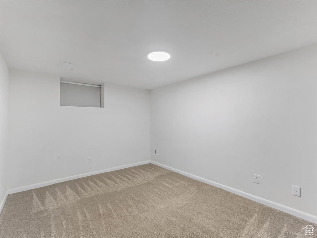 Finished basement with carpet floors and baseboards