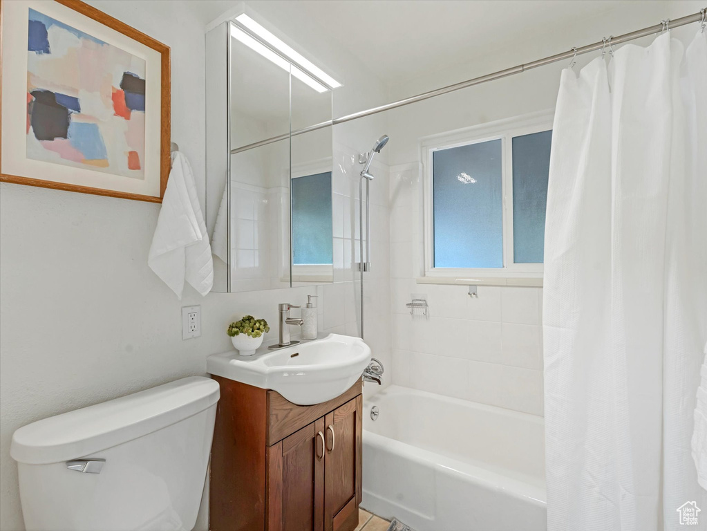 Full bath featuring vanity and shower / bathtub combination with curtain