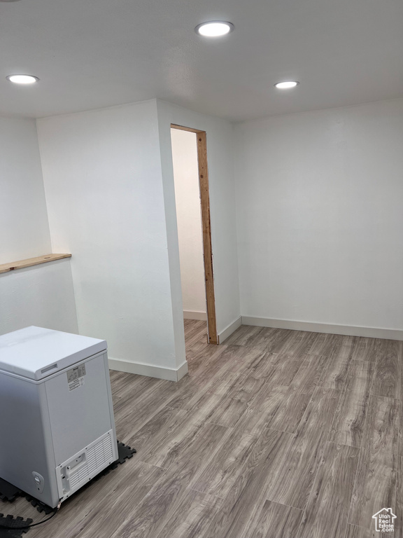 Below grade area featuring light wood-style floors and recessed lighting