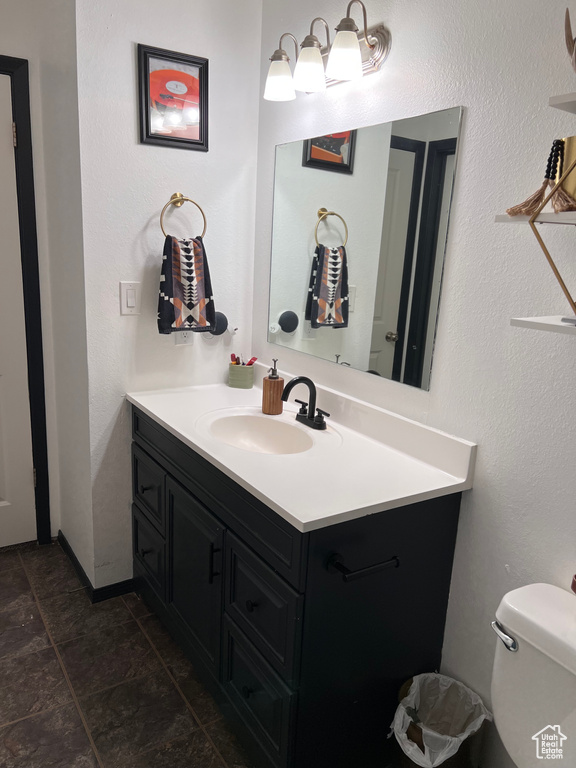 Half bath featuring vanity and tile patterned flooring