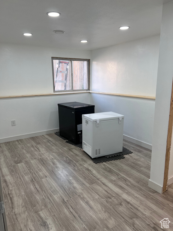 Unfurnished office with wood finished floors and recessed lighting