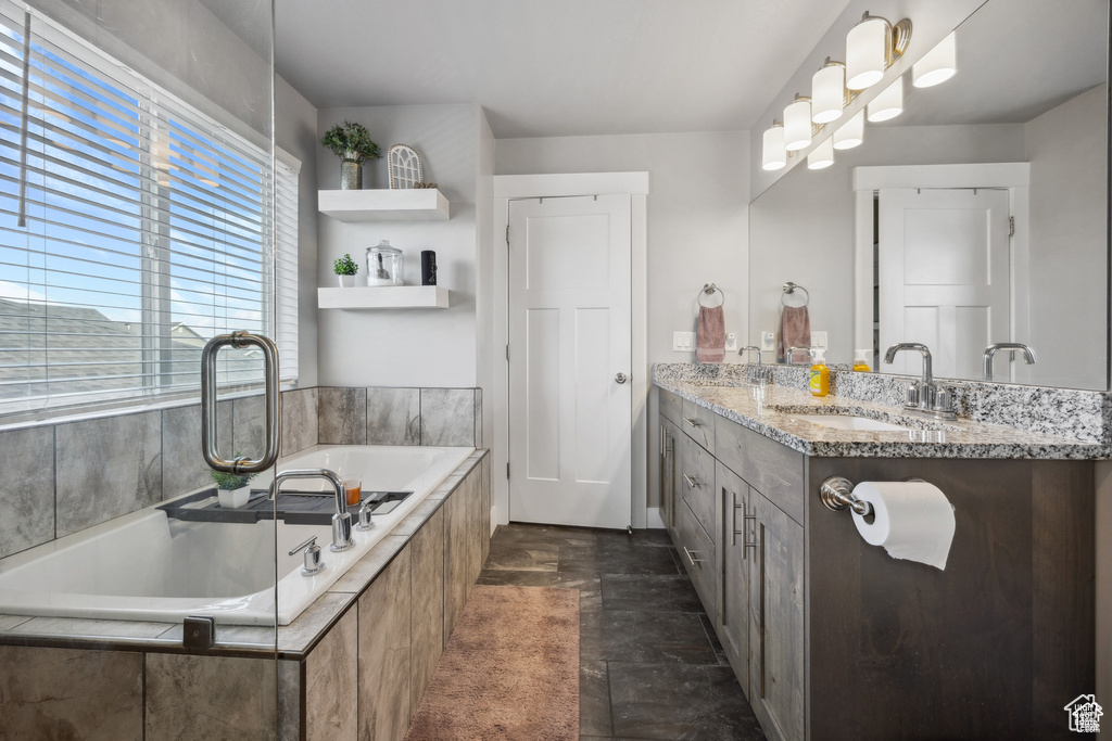 Full bath with double vanity and a bath