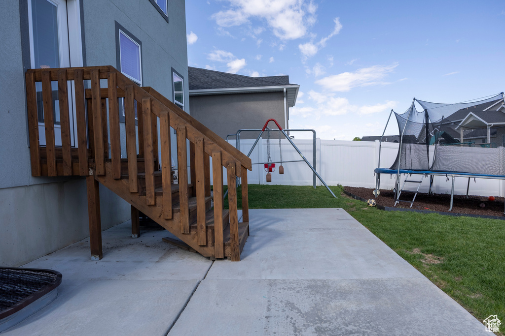 View of patio / terrace featuring a trampoline and stairs