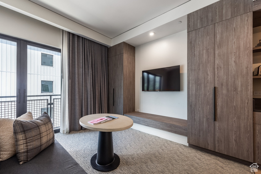 Carpeted living room with recessed lighting