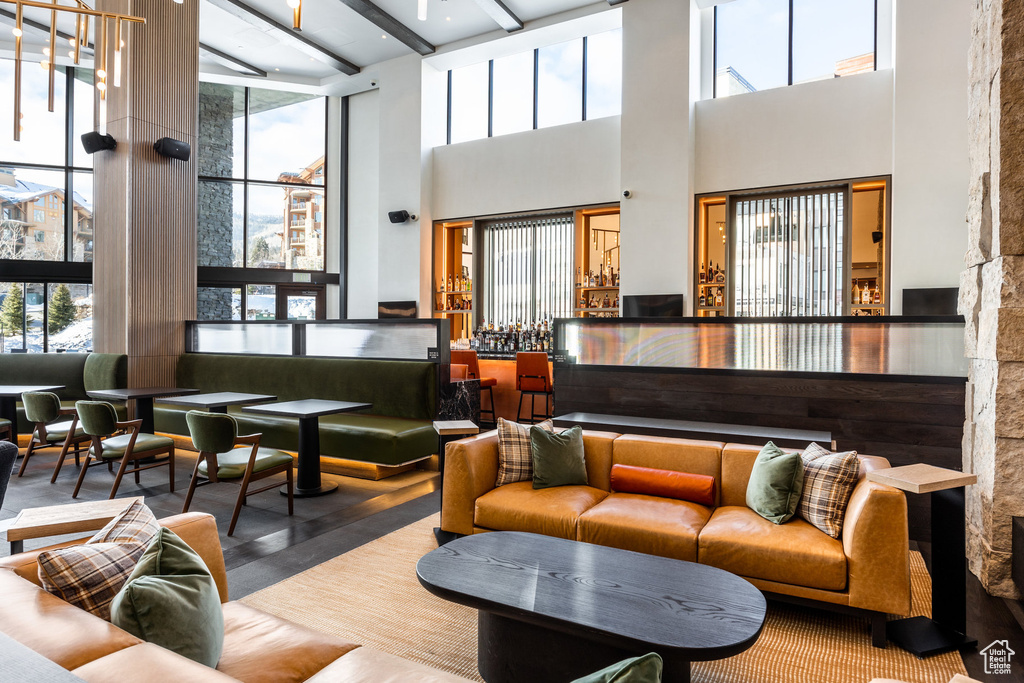 Common area featuring a towering ceiling and beamed ceiling