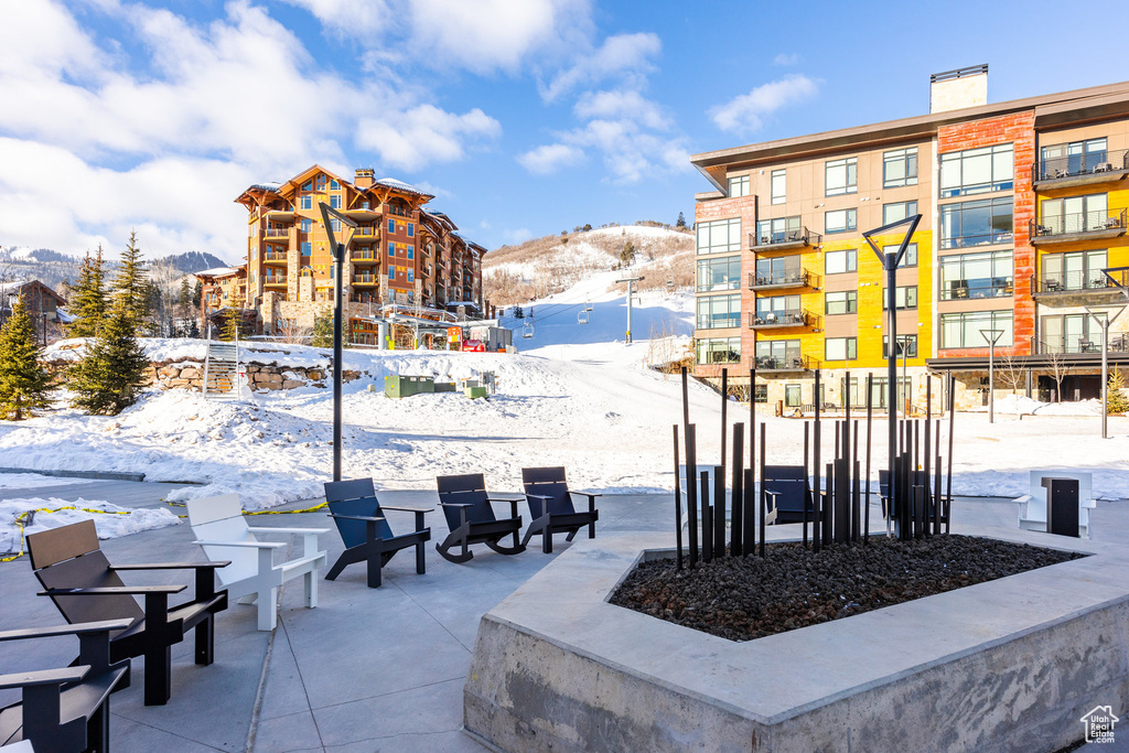 Snow covered patio featuring a mountain view