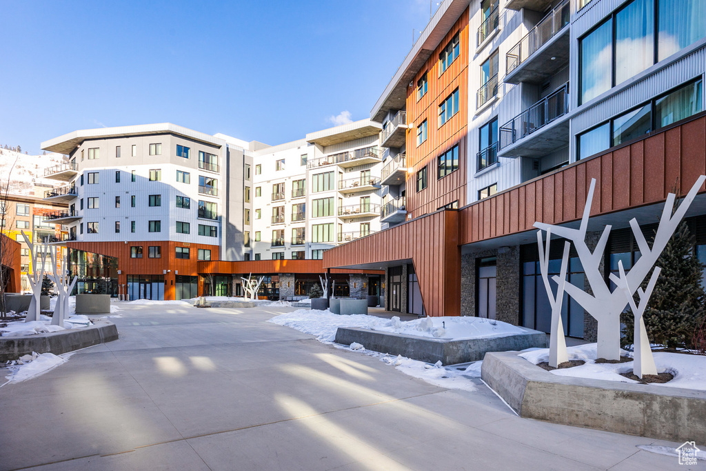 Snow covered property featuring a view of apartment building / complex