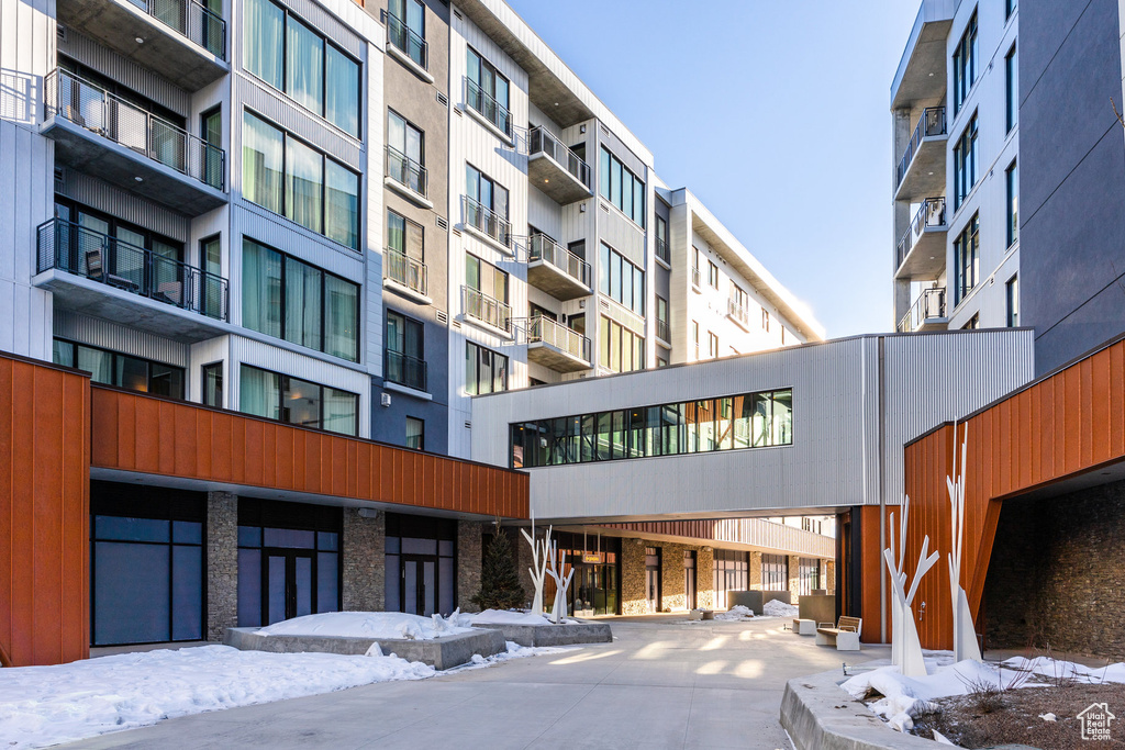 Snow covered property featuring a view of apartment building / complex