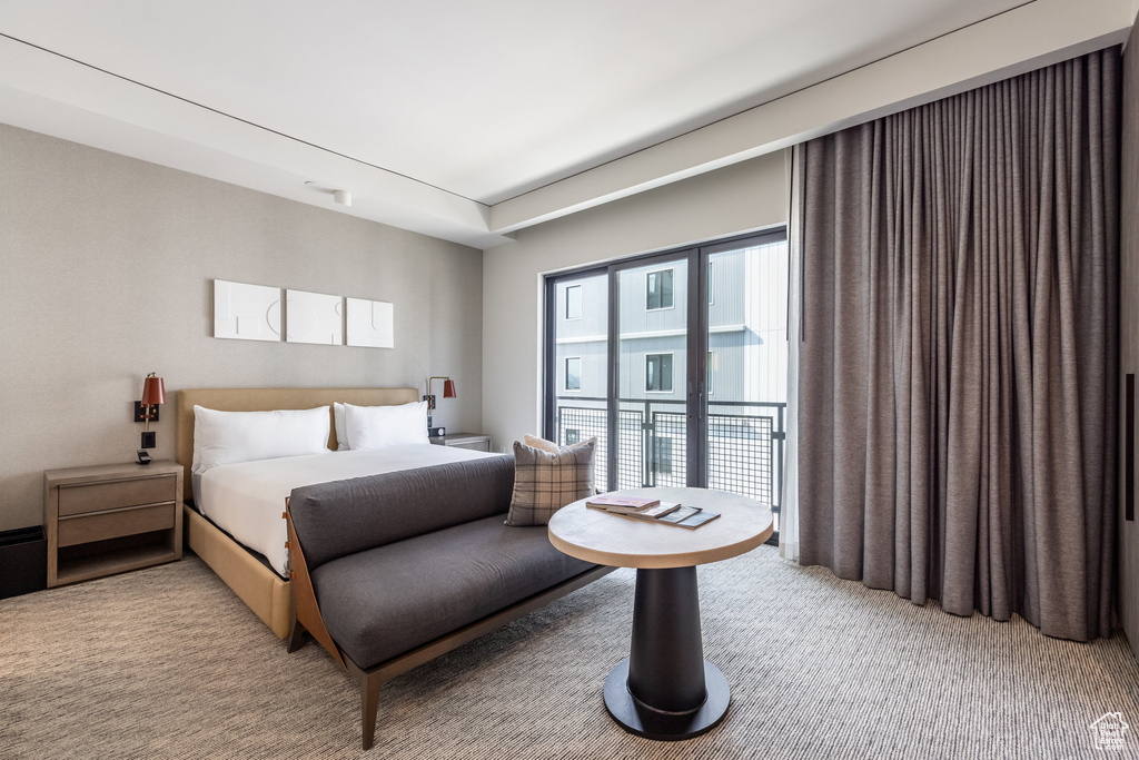 Bedroom featuring light colored carpet and access to exterior