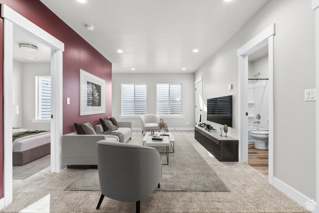 Carpeted living room with baseboards and recessed lighting