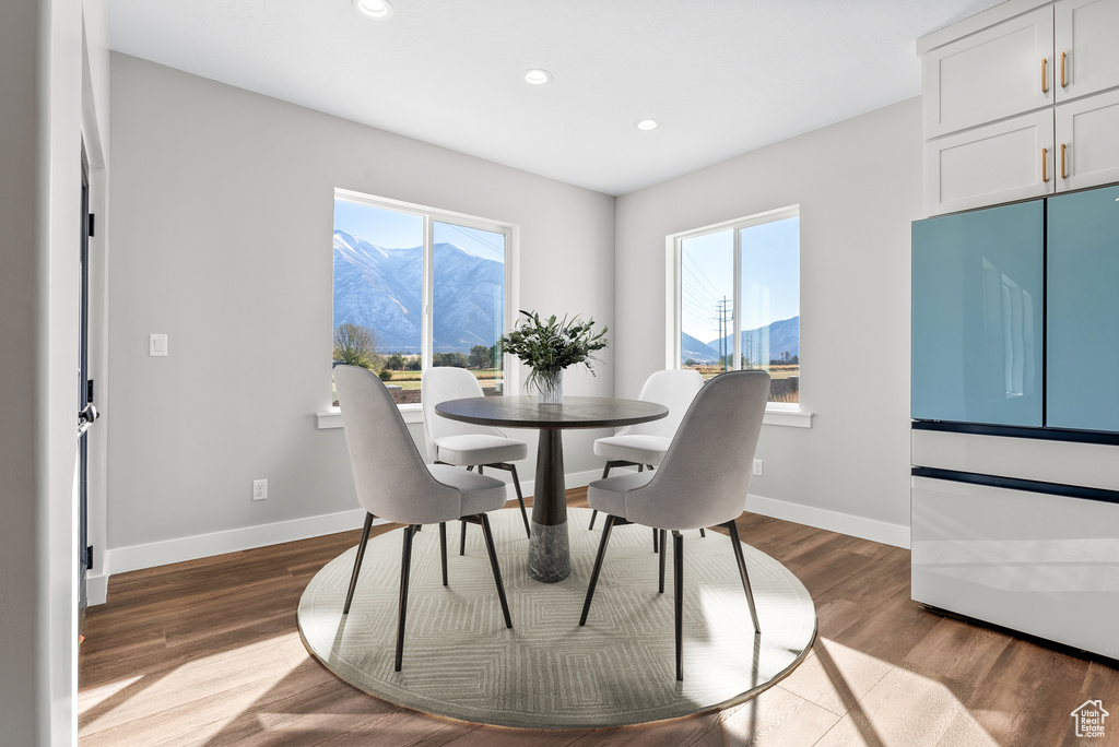 Dining area with a mountain view, plenty of natural light, recessed lighting, and dark wood finished floors