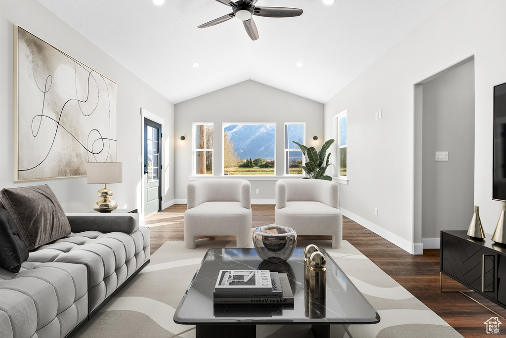 Living area featuring dark wood-style floors, ceiling fan, lofted ceiling, and recessed lighting