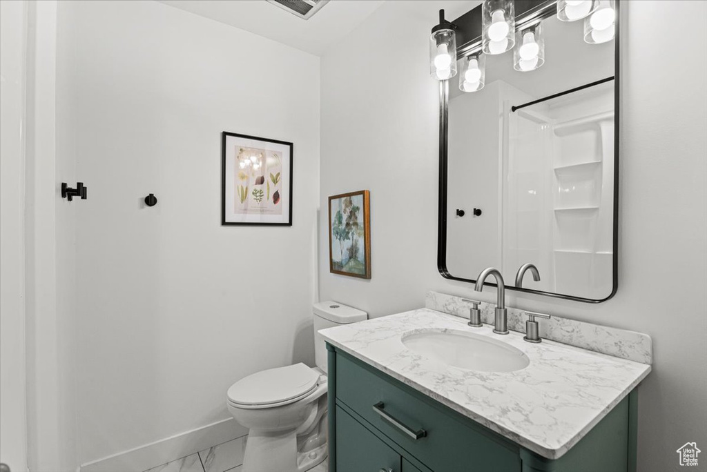 Bathroom with marble finish flooring and vanity
