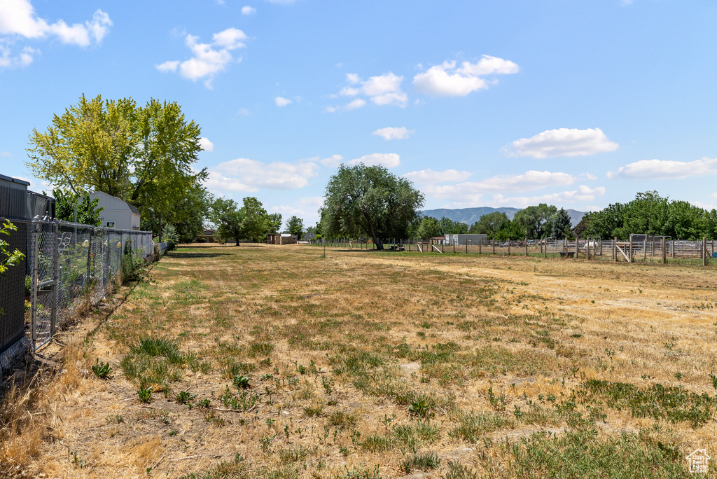 View of yard featuring a rural view and a mountain view