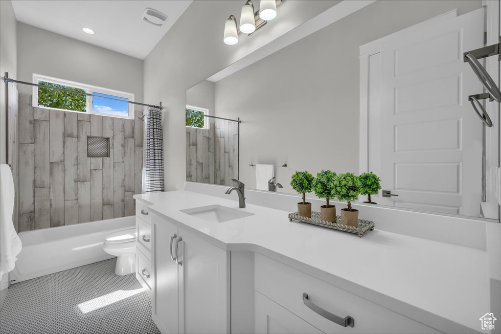 Bathroom featuring vanity, tub / shower combination, and tile patterned floors