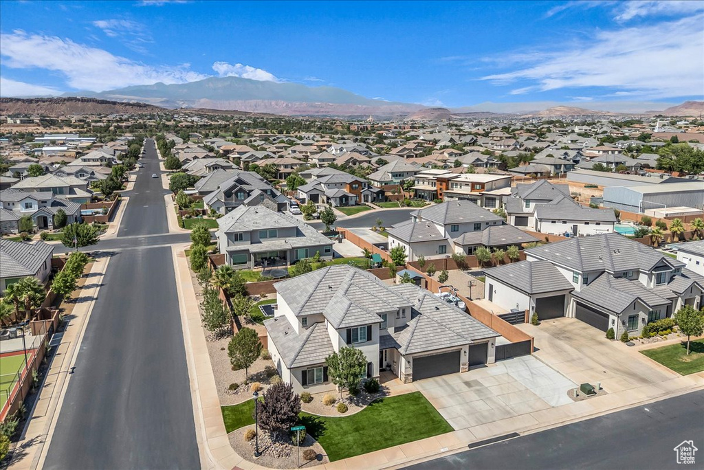 Aerial perspective of suburban area with a mountainous background
