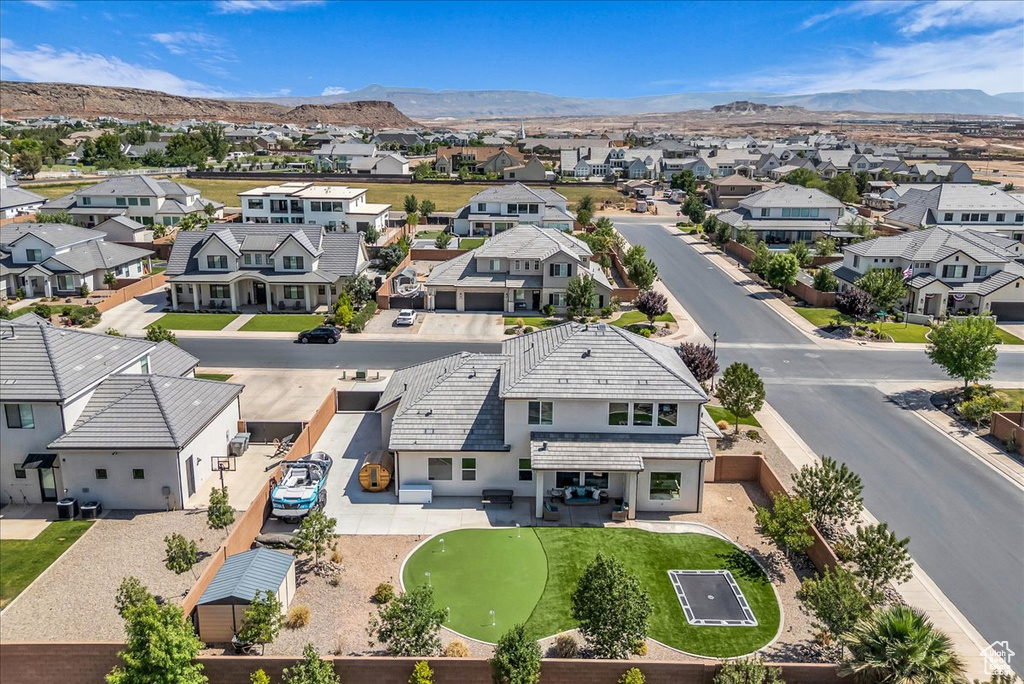 Aerial perspective of suburban area with a mountainous background