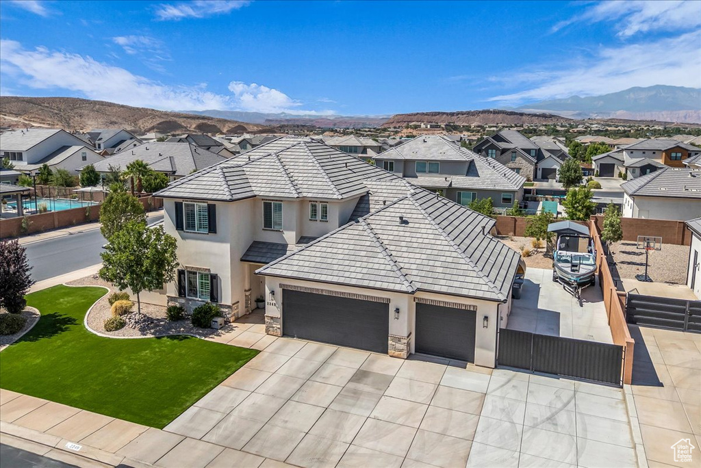 View of front of property featuring stucco siding, a residential view, and a garage