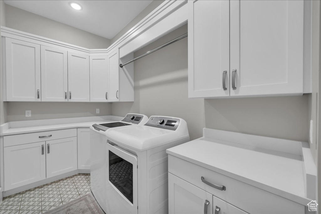 Washroom with washer and clothes dryer, cabinet space, and recessed lighting