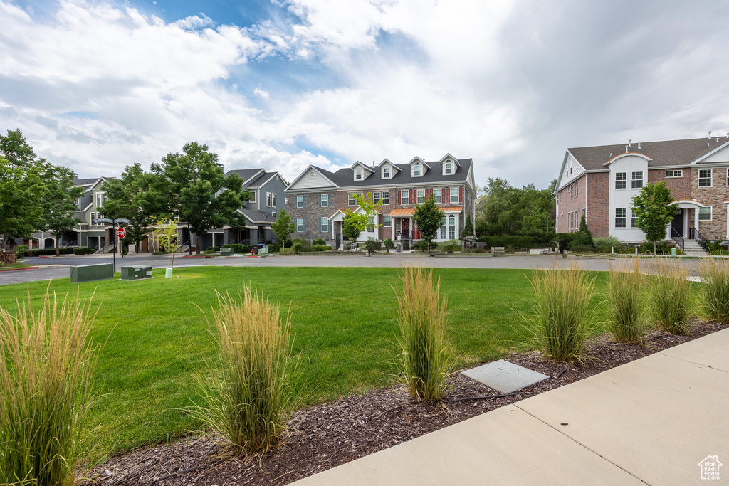 View of home's community with a residential view and a lawn