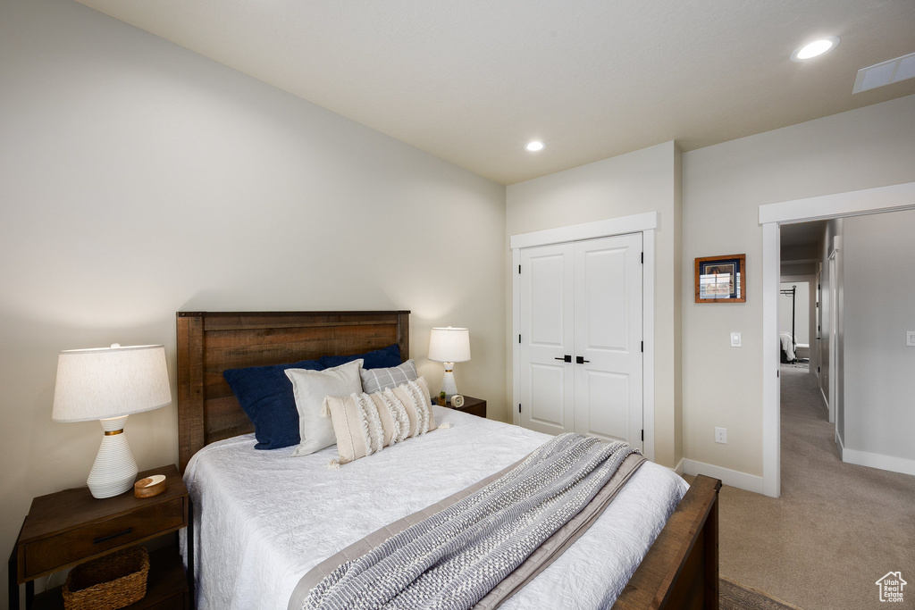 Bedroom featuring carpet, recessed lighting, and a closet