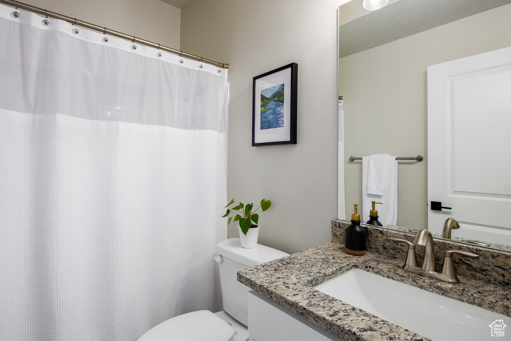 Full bath with vanity and a shower with curtain