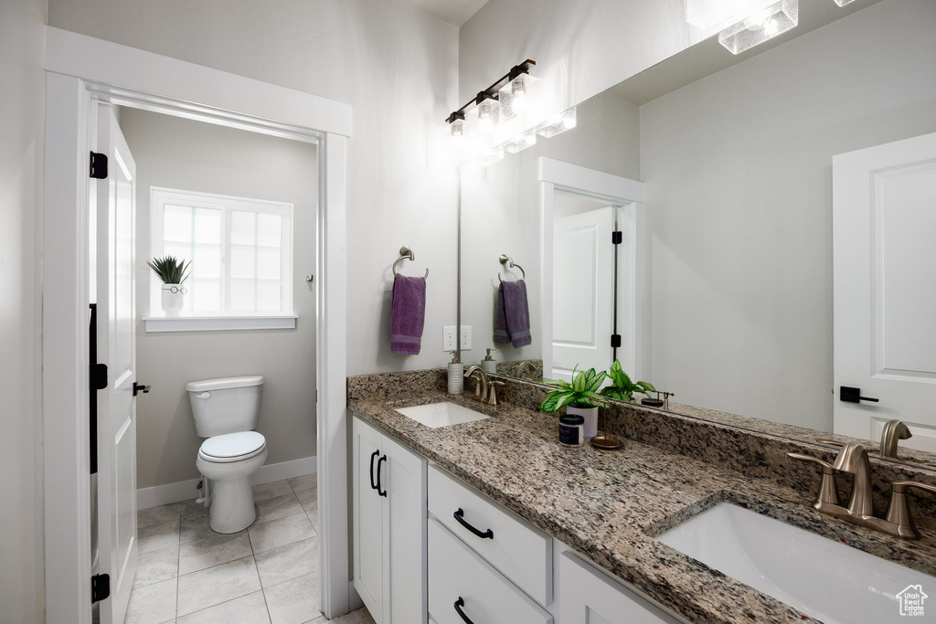 Full bath with double vanity and toilet