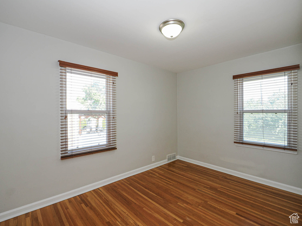 Empty room featuring baseboards and wood finished floors