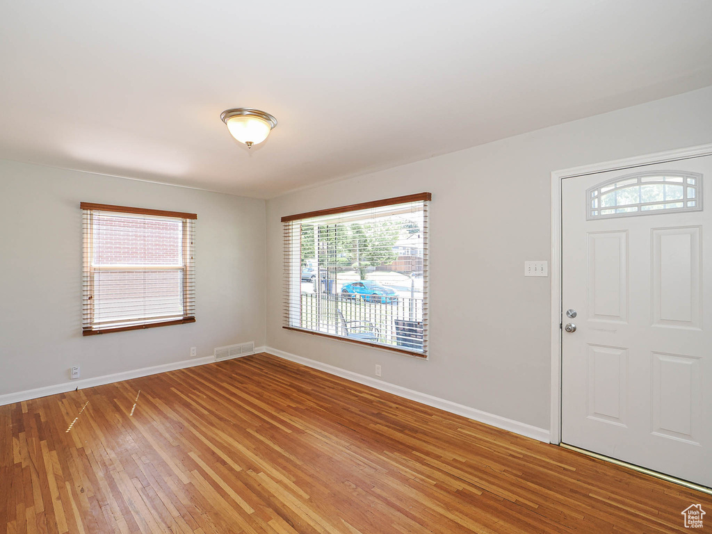 Entrance foyer with light wood-style floors and baseboards
