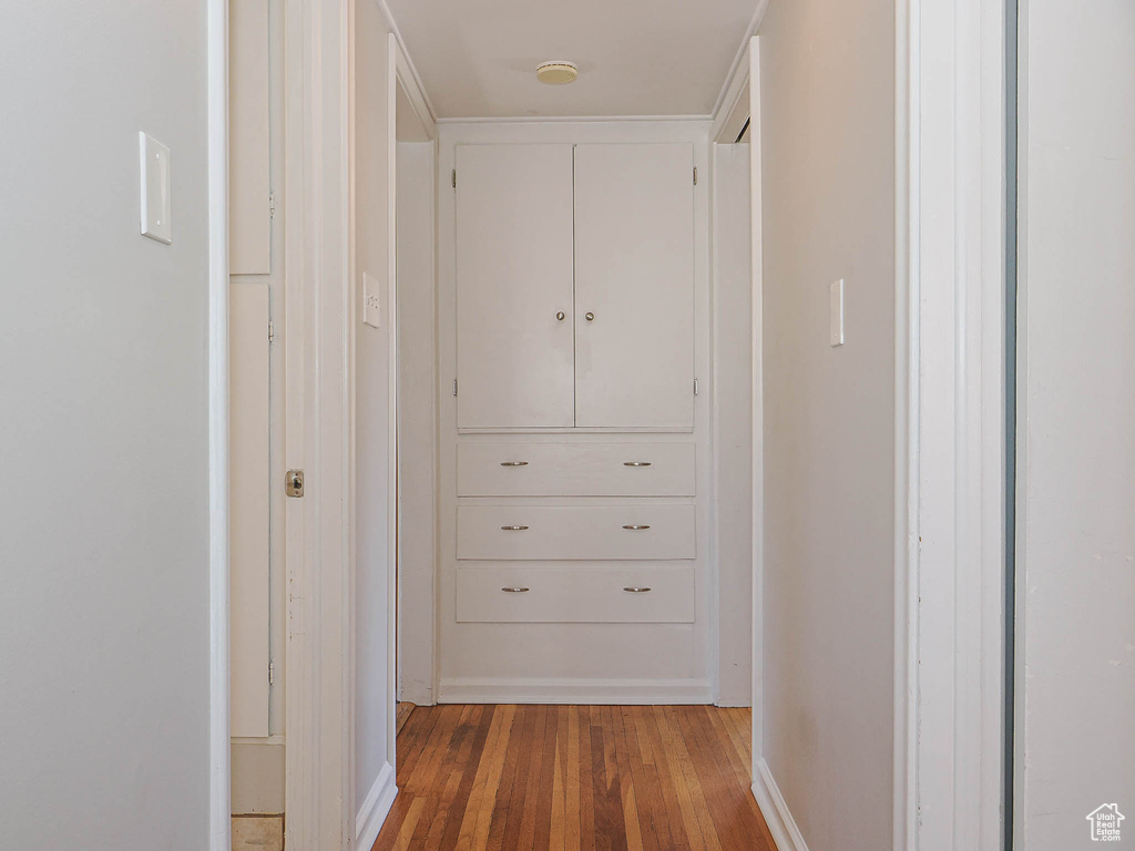 Corridor featuring light wood-type flooring and baseboards