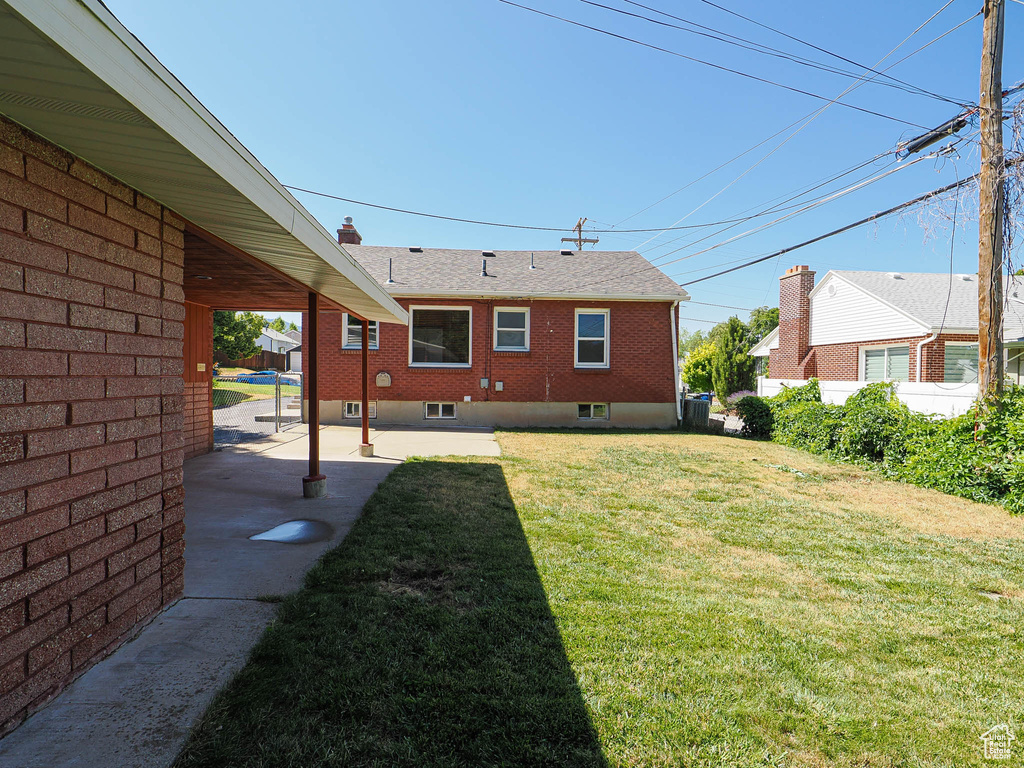 View of green lawn with a patio area