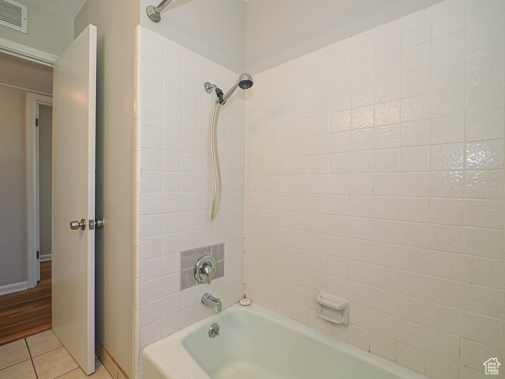 Full bath with shower / bathtub combination and tile patterned flooring