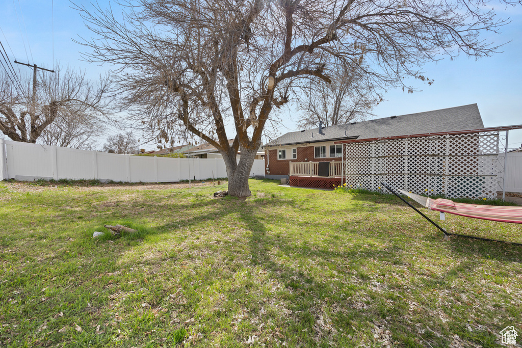 View of yard with a wooden deck