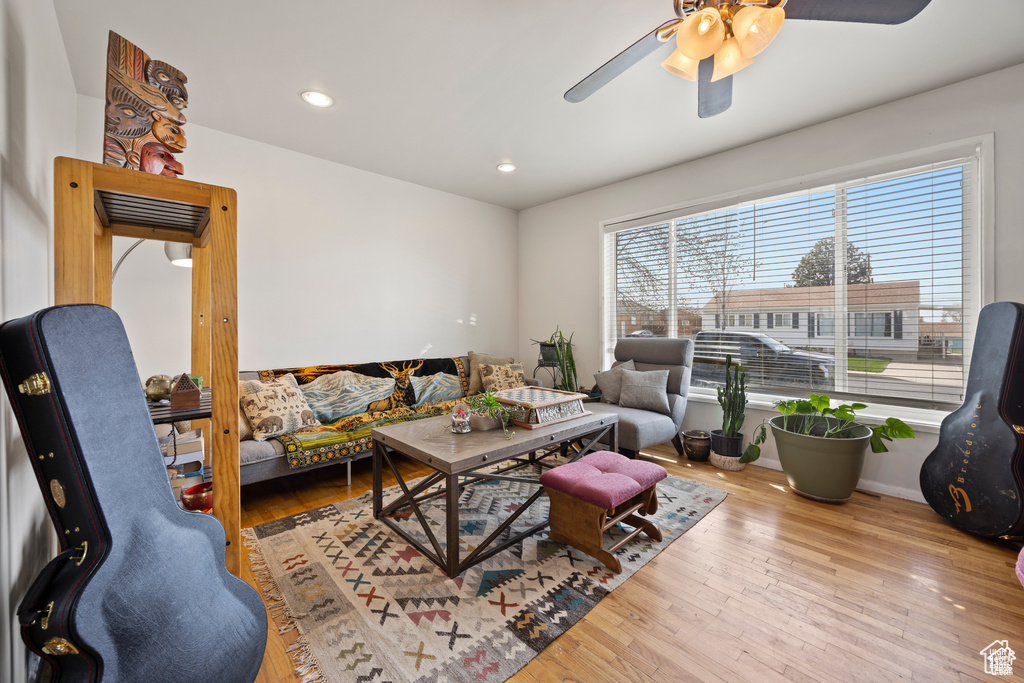 Living area with ceiling fan, hardwood / wood-style floors, and recessed lighting