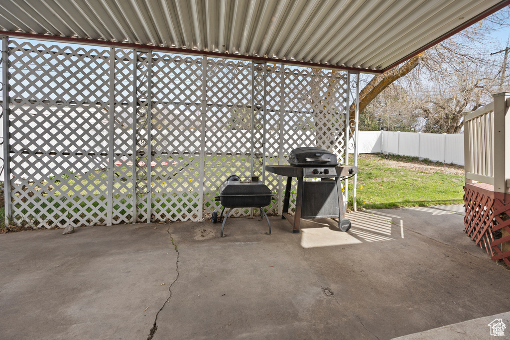 Fenced backyard featuring area for grilling and a patio