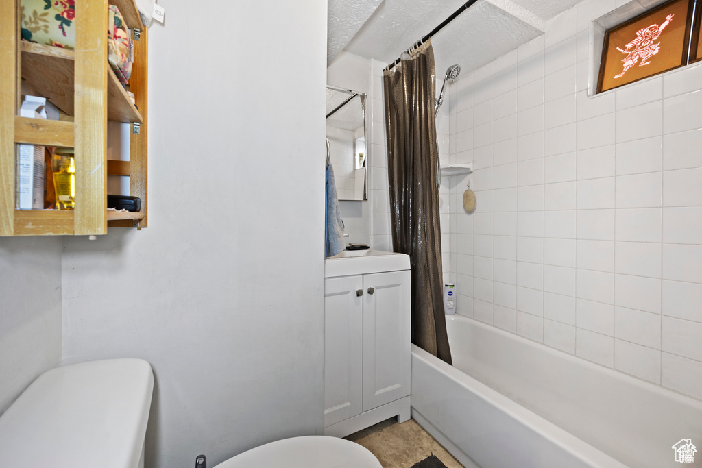 Full bathroom featuring shower / bath combination with curtain and vanity