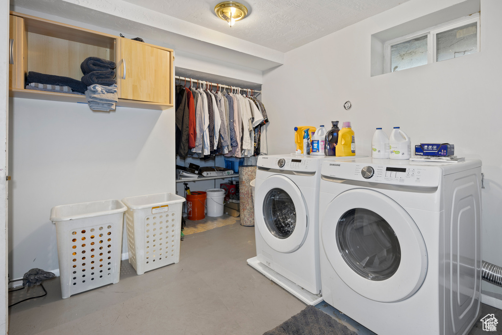 Laundry area with washing machine and clothes dryer and cabinet space