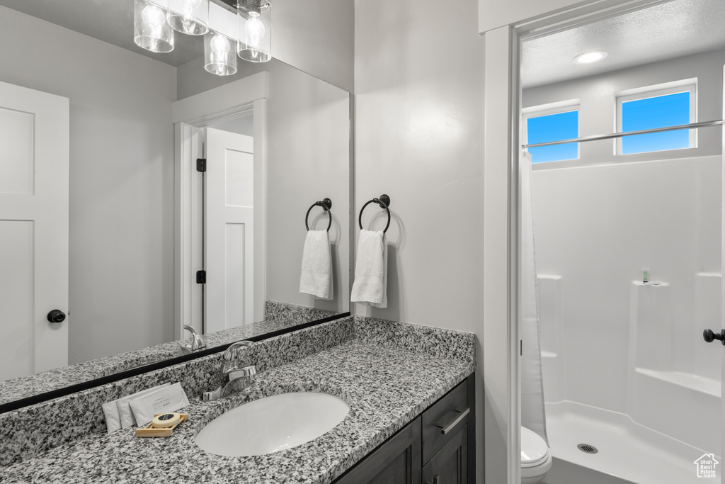 Full bathroom featuring vanity and a stall shower